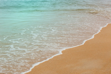 Soft Wave Of Blue Ocean selective focus on sandy beach ,On Sandy Beach Background. Travel in holiday concept