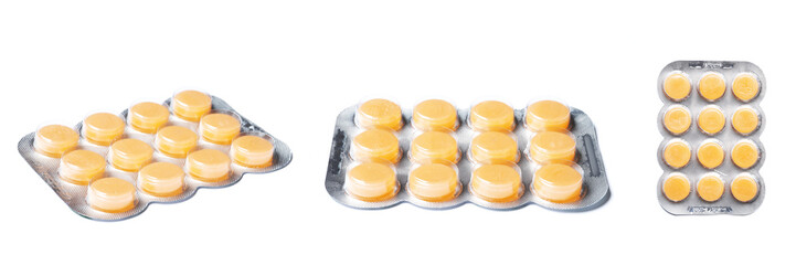 Orange Blisters with color cough drops isolated on a white background.