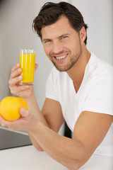 Fototapeta premium happy man drinking orange juice