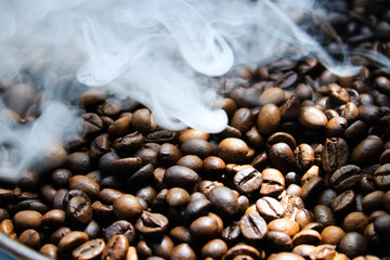 Coffee beans are roasted in a pan