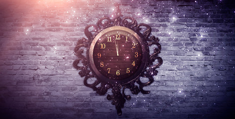 Dark room, spotlight, rays. Old clock in a metal frame. Old brick wall, neon light. Empty room scene, night view.