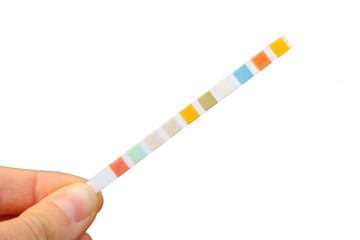 Strip for water quality measurement held in fingers (female hand). Ten multicolor squares for...