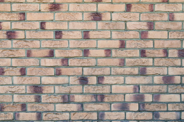 Motley beige and brown bricks background texture 