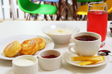 Set breakfast with porridge and cheesecakes