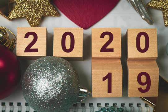 New year 2019-2020 calendar of wooden blocks and Christmas toys on the background, tinted image, selective focus