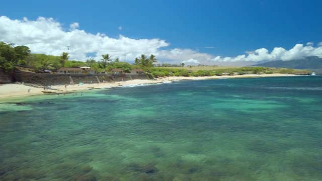Ho'okipa Beach Park in Maui Hawaii, renowned windsurfing and surf site for wind, big waves and big Turtles drying on sand. Snorkeling paradise for coral reefs. Gimbal panning cinematic ProRes 422