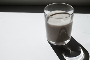 Glass of yogurt on a white background