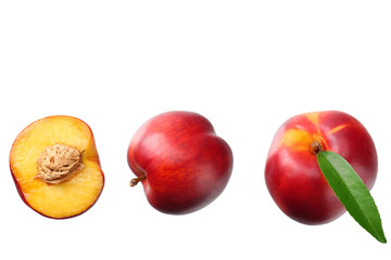 Nectarine with green leaf and slices isolated on white background. top view