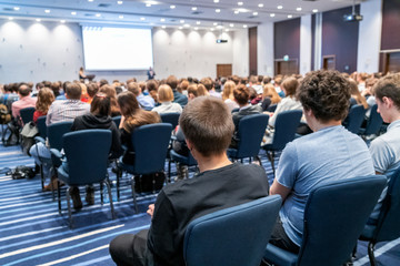 Image of a conference that takes place in a large conference room, workshop for young...