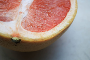 Sliced grapefruits on a stone table