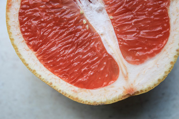 Sliced grapefruits on a stone table