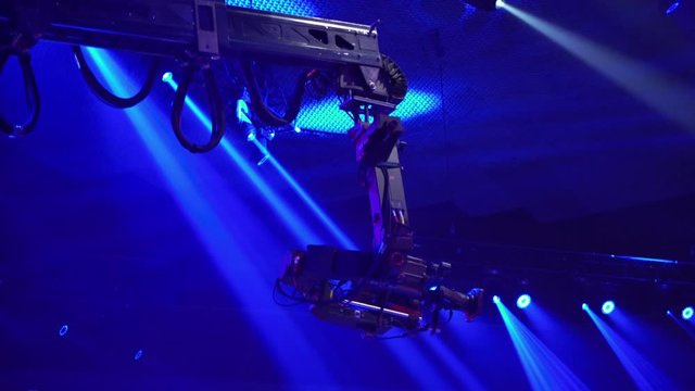 Video camera on the tap when shooting a television show. Live concert. The movement of the camera over the audience under the ceiling. Shooting from a height.