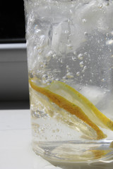Glass with lemon, ice and water