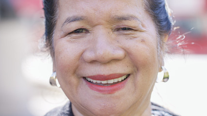 Portrait of happy smiling Filipino female looking to camera with a big grin - 298358819