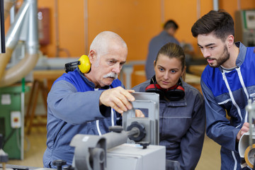 portrait of senior laborer with apprentices