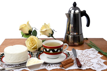 cup of tea with cheese on wooden table, brazilian breakfast
