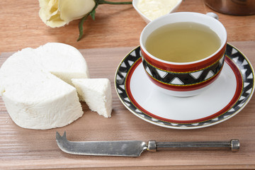 cup of tea with cheese on wooden table, brazilian breakfast