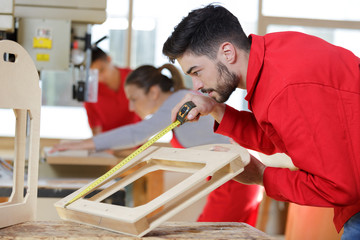 man measuring window prior to installation