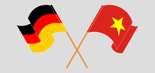 Crossed and waving flags of Vietnam and Germany
