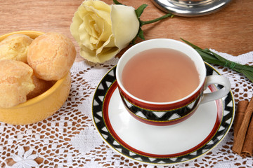 Fototapeta na wymiar cup of tea with cheese on wooden table, brazilian breakfast