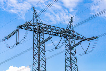 Electric transmission insulators are seen in detail with arcing horns and stock bridge dampers,...