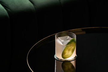Fresh cocktail glass on glass table in night club restaurant