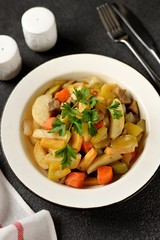 Baked potatoes, carrots, turnips, onions, eggplant and zucchini with olive oil in the oven. Wholesome, healthy homemade food.