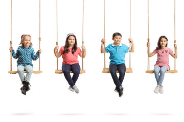 Four children sitting on swings - obrazy, fototapety, plakaty