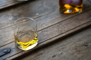 Wonderful single malt in glasses on used wooden barrel