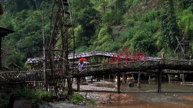 Famous Cat Cat Waterwheels in Northern Vietnam spinning in the river on a hot day in Autumn
