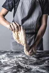 Robienie ciasta bochenka chleba mąką osoba w fartuchu piekarz