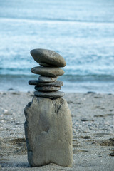 Fototapeta na wymiar Large stacked Zen balancing rocks on a Cornwall beach 