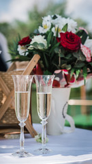 glasses with champagne at a wedding on the background of the newlyweds 2