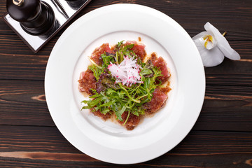 Fish salad. Tuna and rucola. on a white plate