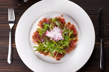 Fish salad. Tuna and rucola. on a white plate