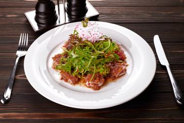 Fish salad. Tuna and rucola. on a white plate