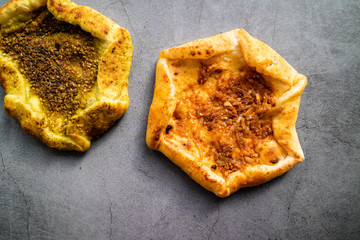 Red Jerusalem pita bread with sesame, onion and tomato on concrete background. Israeli cuisine. Top view.