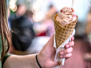 Ice cream cone in hand.