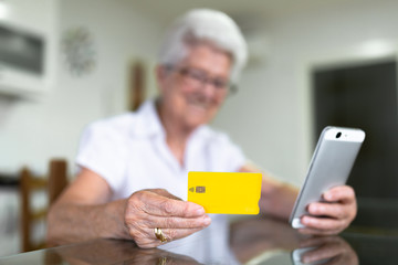 older woman at home with new technologies