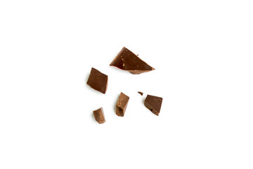 The pieces of a broken chocolate bar isolated on white