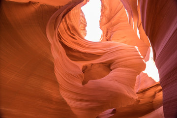 Beautiful wide angle view of amazing sandstone formations in famous Antelope Canyon on a sunny day with blue sky near the old town of Page at Lake Powell, American Southwest, Arizona, USA