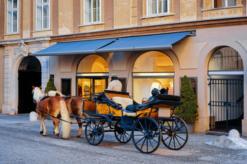 Horse fiaker on street with snow in Salzburg of Austria