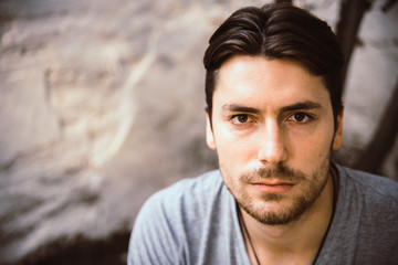 Portrait of young male model with serious face looking at camera, casual clothes.