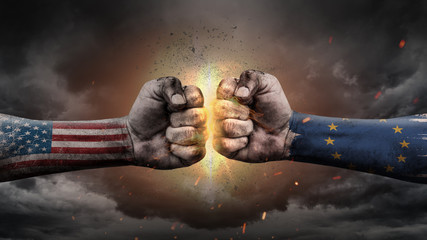 USA vs EU. Fists with flags. Battle of two countries on sky.