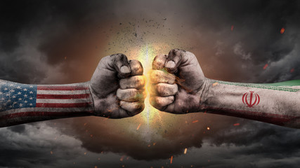 USA vs Iran. Fists with flags. Battle of two countries on sky.
