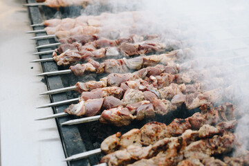 Beef and pork bbq being prepared on skewers