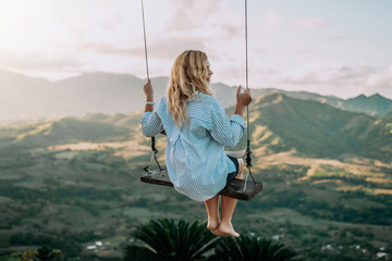 Beautiful view of young woman swing on the top of the mountan Redonda in Dominican Republic. Concept travel, vacation - obrazy, fototapety, plakaty