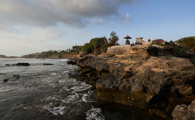 Fototapeta na wymiar Panoramic landscap Bali rock ocean coast at the sunset time with beauty light