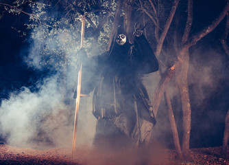 Portrait of grim reaper, the angel of death ( Azrael ) lurking through the woods at night...