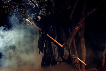 Portrait of grim reaper, the angel of death ( Azrael ) lurking through the woods at night...